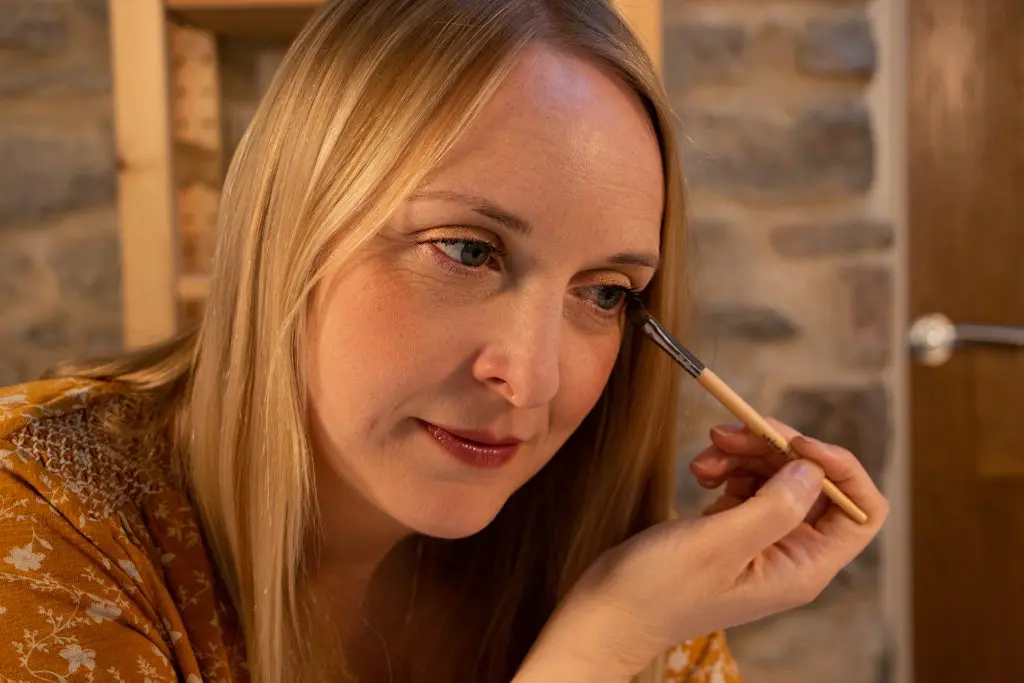 Woman applying makeup with brush