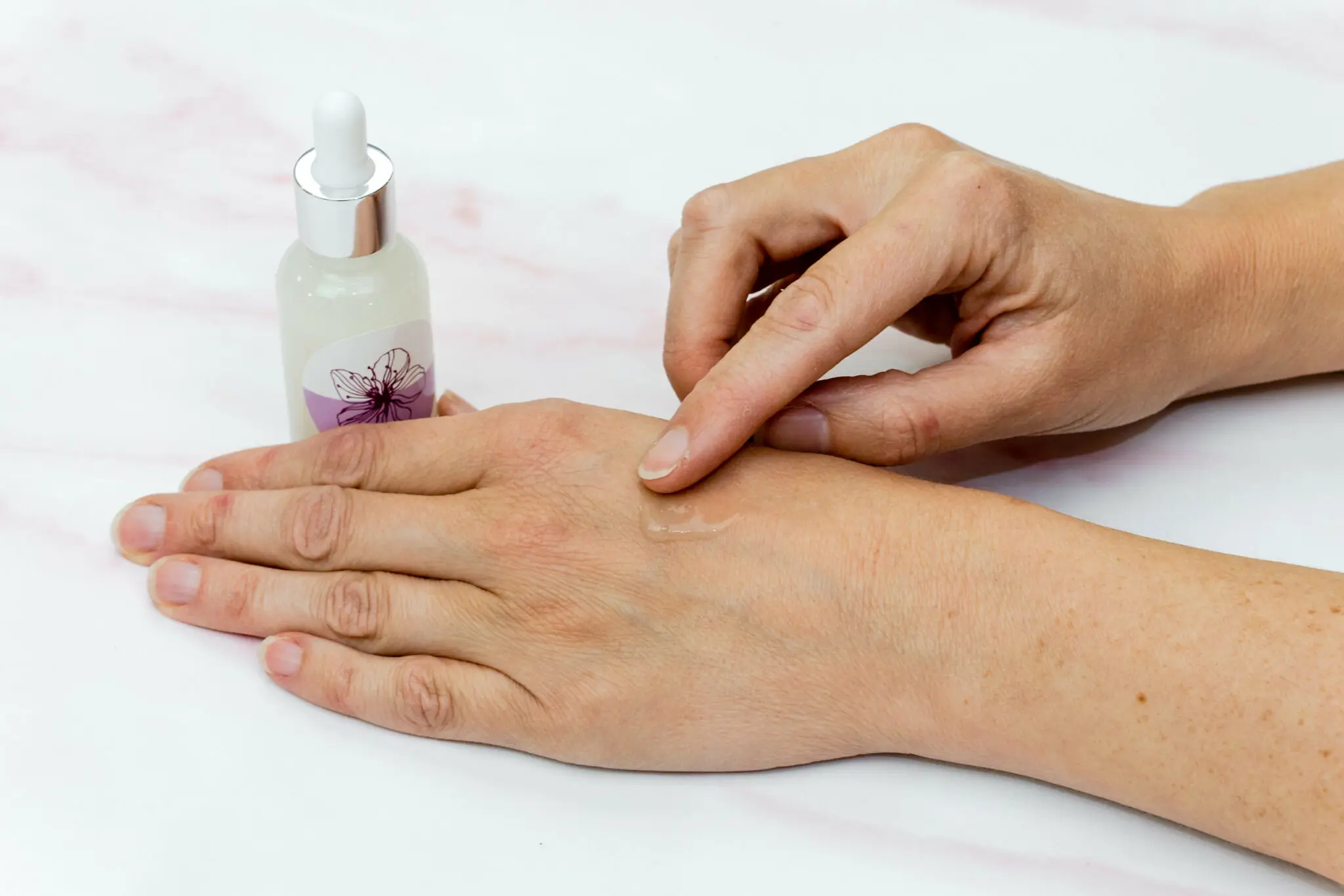 Applying serum to hand for skincare routine