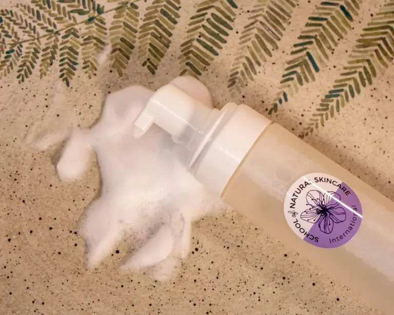 Foaming skincare product with botanical design on label.