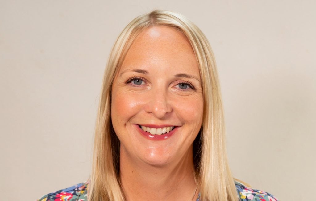 Smiling woman with long blonde hair