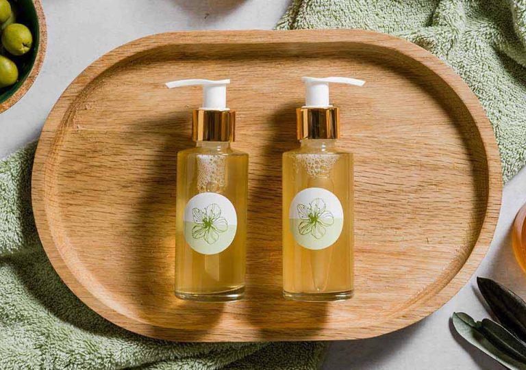 Two olive oil bottles on wooden tray