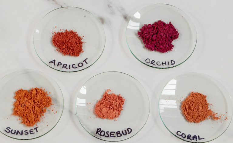 Five plates of colorful powdered pigments labeled.