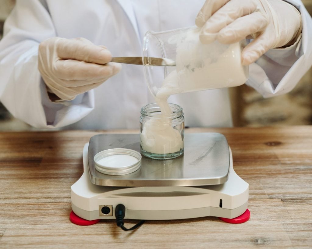 Measuring cream in a jar on digital scale