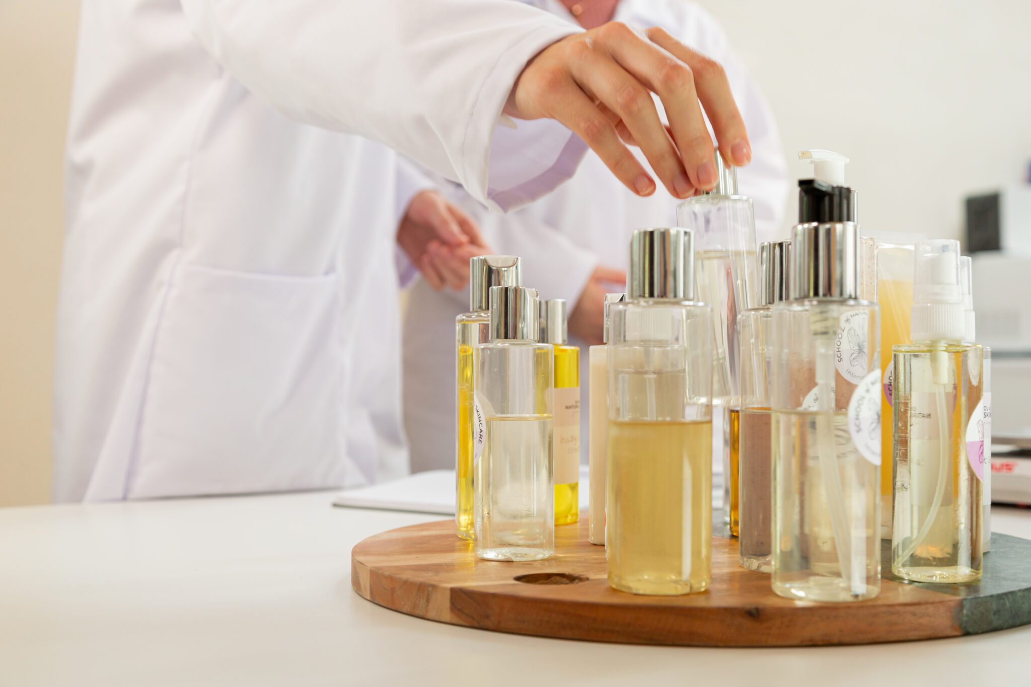 Person selecting a fragrance bottle in a lab.